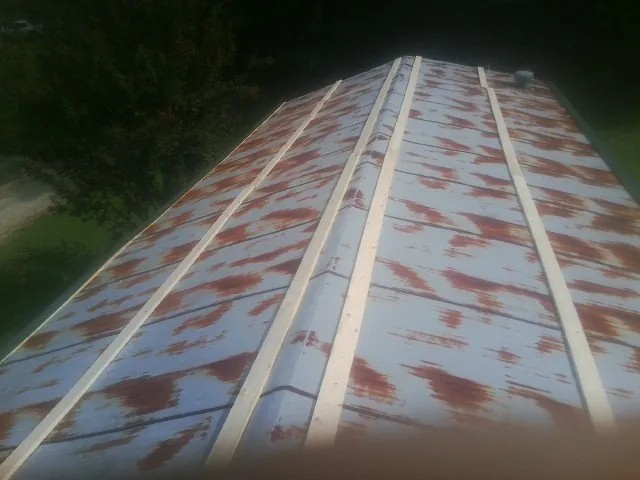 Rusted metal roof panels with new wood purlins before replacement — Storm Damage Roof Repair in Accokeek by Roofing Brothers