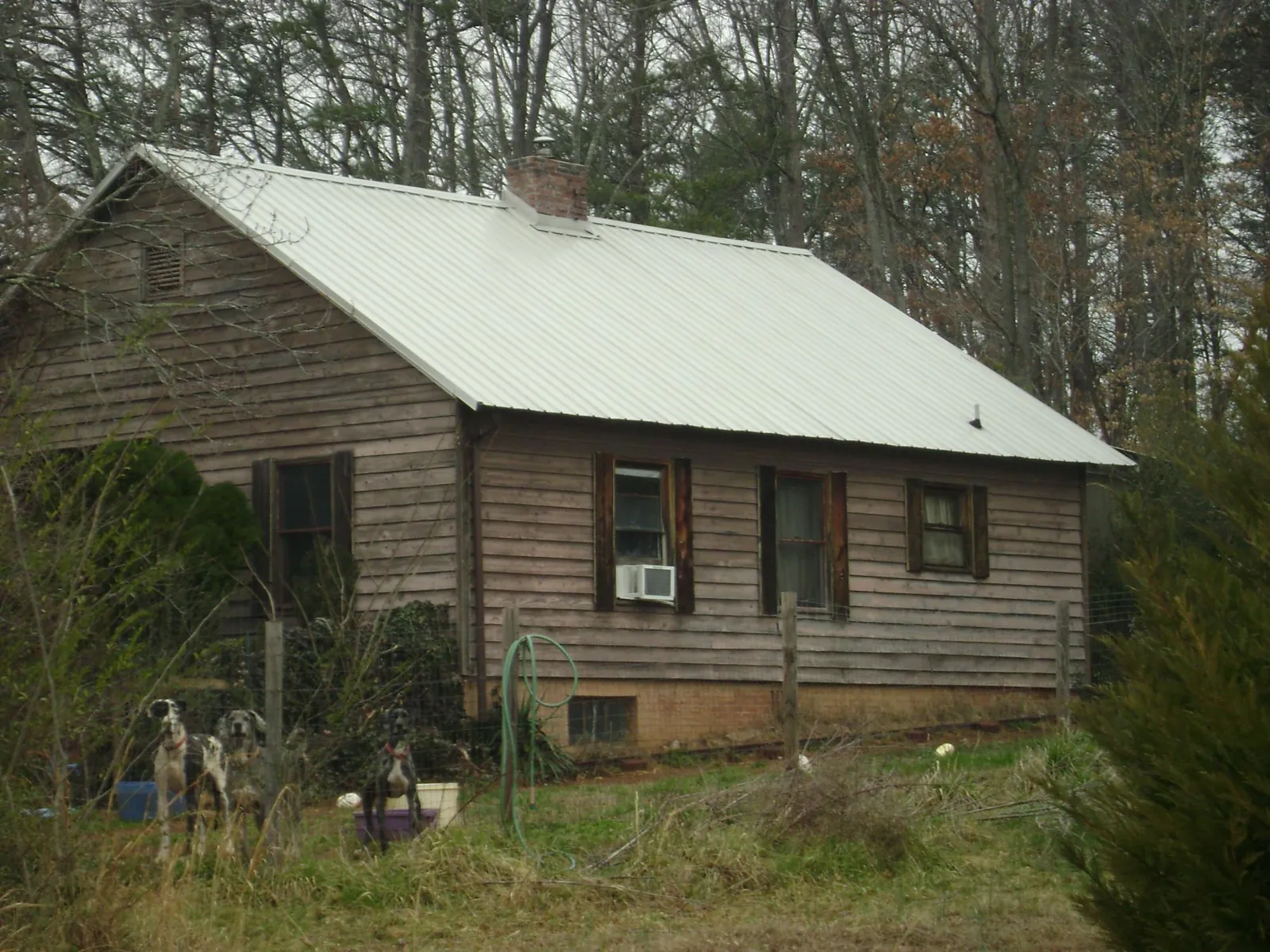 White metal roof on an old wood sided farmhouse, from a Metal Roof Installation job in Accokeek